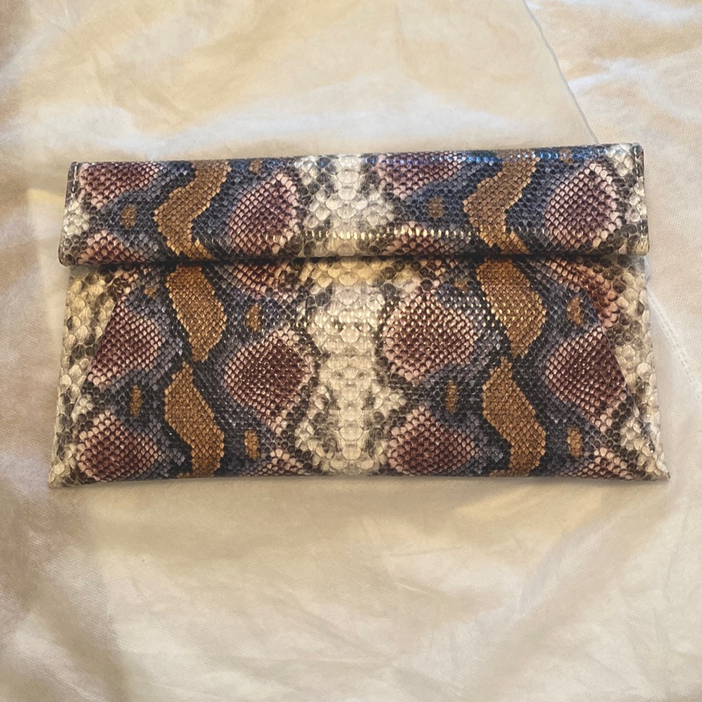 Urban Expressions multi-color snake print envelope style clutch.